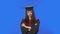 Portrait of female student in cap and gown graduation costume is indignantly talking to someone. Young brunette woman