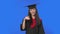 Portrait of female student in cap and gown graduation costume waving hand and showing gesture come here. Young brunette