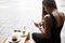 Portrait of a female student using touch pad while sitting in coffee shop outdoors