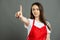 Portrait of female supermarket employee making wait a minute gesture