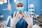 Portrait of female surgeon showing surgical gloves in operation room