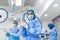 Portrait of female surgeon in surgical uniform in operation theater looking away. Doctor in scrubs and medical mask in modern