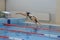 Portrait of a female swimmer, that jumping and diving into indoor sport swimming pool. Sporty woman