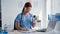 portrait of female veterinarian examining small rodent and writing readings on form while sitting in office of clinic