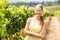 Portrait of female vintner standing with arms crossed