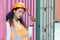 Portrait of female worker In Cargo Containers In Shipping Container Yard. woman holding walkie-talkie and digital tablet