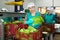 Portrait of female worker standing with fresh lettuce in her hands at vegetable sorting factory