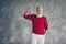 Portrait of festive charming old man enjoy x-mas newyear preparation hold golden christmas tree toy wear jumper white