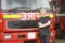 Portrait of a firefighter standing by an engine