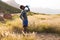 Portrait of fit african american man in sportswear resting drinking water in tall grass