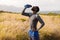 Portrait of fit african american man in sportswear resting drinking water in tall grass