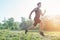 Portrait of fit athletic man jogging on the street in morning summer day. Outdoors training in fresh air