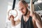 Portrait of fit male holding gymnastic rings at the gym and looking away