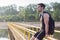 Portrait of fit man runner sitting and resting outdoors near river.