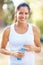 Portrait, fitness or happy woman with water in a park for running, wellness or training with bokeh. Sports, liquid and