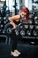Portrait of fitness woman doing barbell workout at gym