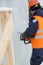 Portrait of a fitter in an orange vest with a chainsaw in his hands