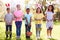 Portrait Of Five Children Wearing Bunny Ears On Easter Egg Hunt In Garden