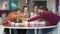 Portrait of five young Caucasian university students studying together in cafe. Male and female friends working on