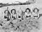 Portrait of five young women lying on the beach and smiling