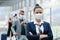 Portrait of flight attendant standing on airport, wearing face masks.