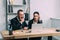 portrait of focused business people in suits using laptop together at workplace