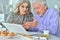 Portrait of focused senior couple using laptop