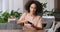 Portrait of focused young afro american woman black girl teenager with curly hairstyle playing online game using phone