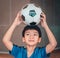 Portrait Football Asian boy holding soccer ball on his head for Youth sport concept