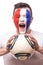 Portrait Football fan of France national football team with ball in hands screaming