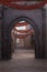 Portrait format 3D rendering of an archway in a narrow street of an old medieval Arabian town