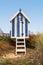 Portrait format blue striped beach hut with steps, Filey, UK