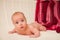 Portrait of four month caucasian baby on knitted plaid in selective focus