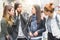 Portrait of four pretty girl friends, gossip on the street