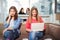 Portrait of four teenager girls sitting at the table in the cafe