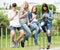 Portrait of four teenagers sitting with their mobile phones outdoors