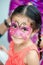 Portrait of a four year old cute pretty girl child young with her face painted for fun at a birthday party