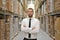 portrait friendly businessman manager in suit working in the warehouse of a company