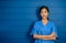Portrait of friendly, cheerful, smiling confident Asian woman doctor or nurse in blue suit.