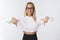 Portrait of friendly-looking pleasant and helpful young female personal assistant in glasses and stylish cropped sweater