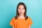 Portrait of friendly schoolgirl with straight hairdo dressed orange t-shirt pouted lips send kiss isolated on turquoise