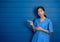 Portrait of friendly, smiling confident Asian woman doctor or nurse in blue suit.