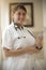 Portrait of friendly, smiling female doctor, healthcare professional wearing lab coat and stethoscope, arms crossed. Latino nurse
