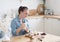 Portrait of friendly smiling female make a cupcake with cream. Indoors image.