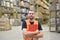 portrait of friendly warehouse worker in a forwarding agency - interior with forklift - transport and storage of goods