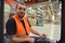 portrait of friendly warehouse worker in a forwarding agency - interior with forklift - transport and storage of goods