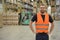 portrait of friendly warehouse worker in a forwarding agency - interior with forklift - transport and storage of goods