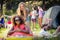 Portrait of friends leaning on beach ball at campsite