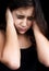 Portrait of a frightened girl on black background