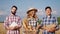 Portrait in front of the camera in the middle of young wheat field family business concept of agriculture and farming